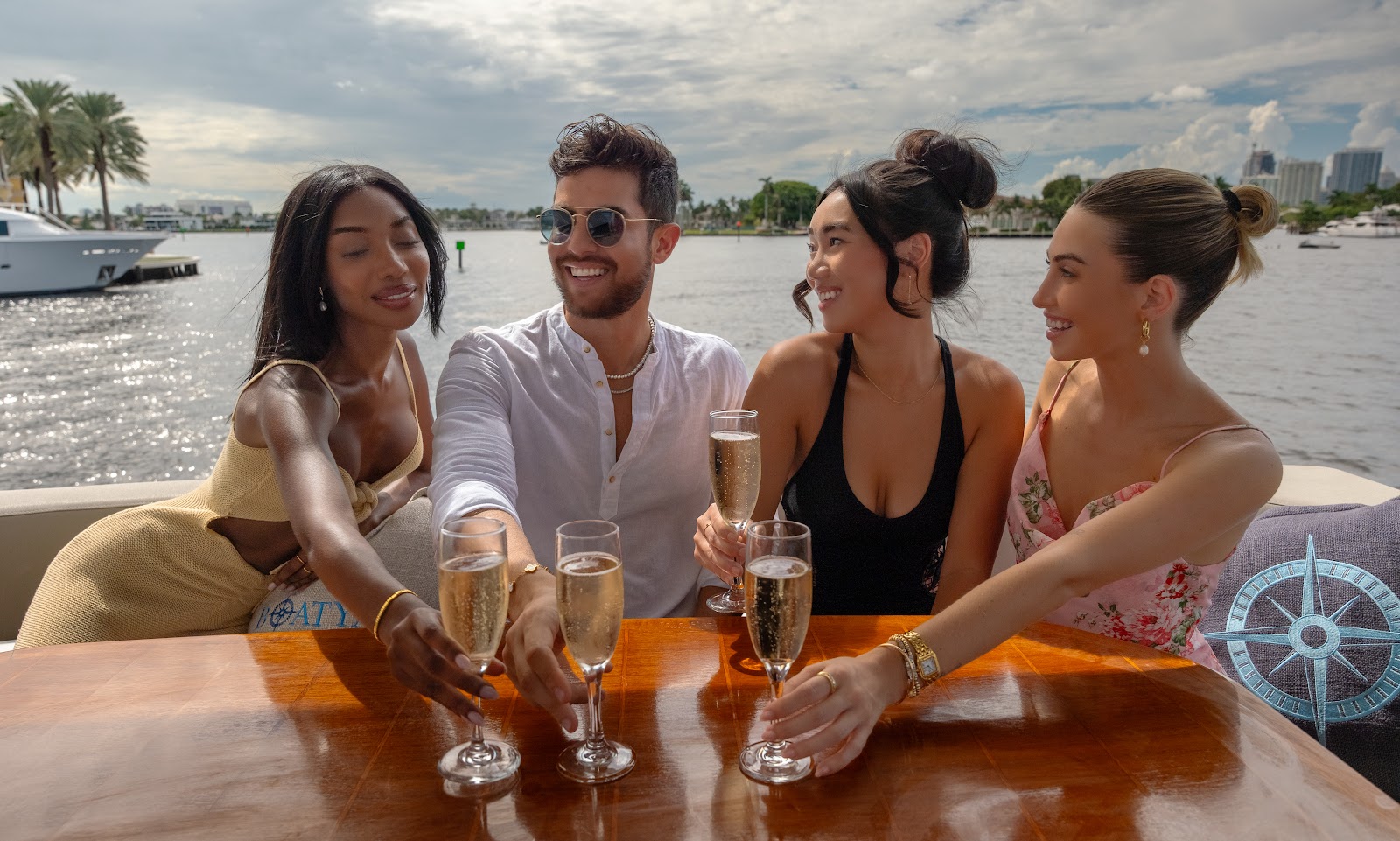 Group celebrating a birthday dinner on a yacht near waterfront restaurants in Fort Lauderdale.